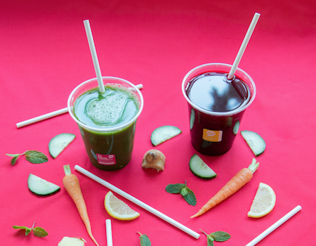 GREEN HOME paper straws inside cups of fresh vegetable juice